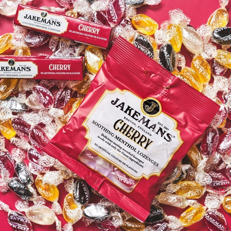 Jakemans Cherry Menthol Lozenges bag packaging cherry flavour 12 x 73g serving suggestion image