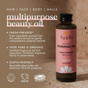 Fushi Organic Moringa Oil bottle with product details on a brown background