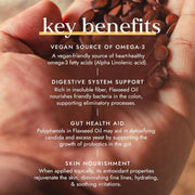 Hand holding flaxseeds with text about key benefits on a blurred background