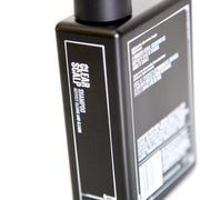 Side image: Uppercut Deluxe Clear Scalp Shampoo 240ml bottle fresh woods pepper fragrance packaging