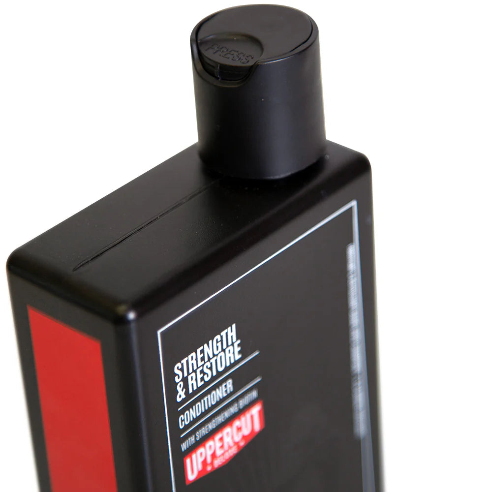 Side image: Uppercut Deluxe Strength and Restore Conditioner 240ml bottle mandarin patchouli fragrance packaging