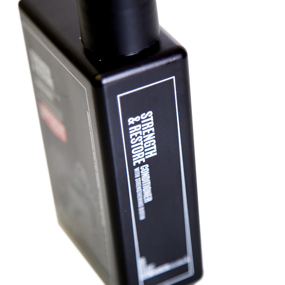 Side image: Uppercut Deluxe Strength and Restore Conditioner 240ml bottle mandarin patchouli fragrance packaging